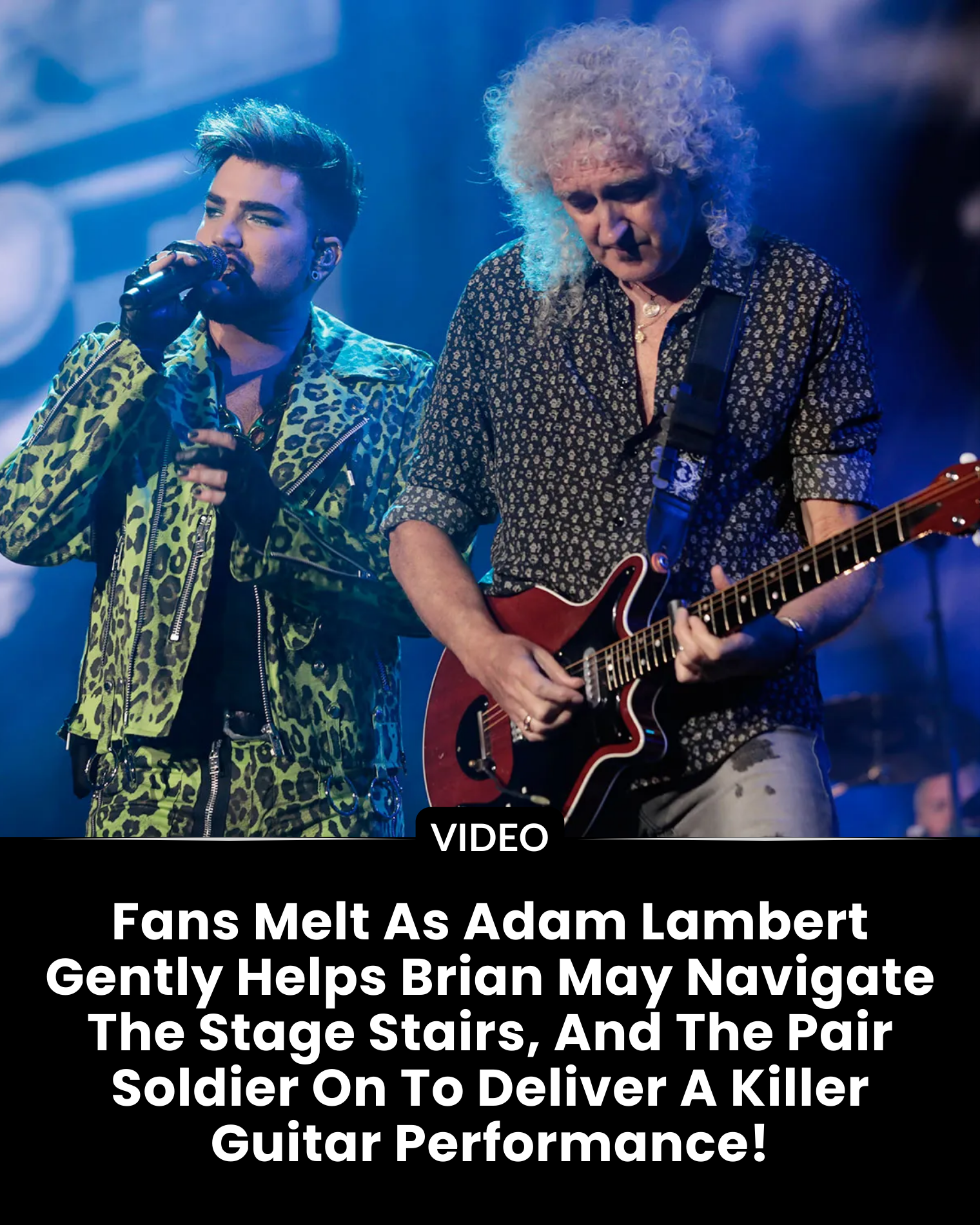 Fans Melt As Adam Lambert Gently Helps Brian May Navigate The Stage Stairs, And The Pair Soldier On To Deliver A Killer Guitar Performance!